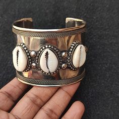 You will receive very beautiful  Cowries Charm Antic look Tribal bangle Bracelet.  Stone :Cowries  Bangle Width  : 2"  approx. Innerdiameter : 2.4"  approx. Many thanks for you visit my store ♥ if you have any question please contact us. For wholesale Price Please Convo me. You can order different items as many you like . White Bohemian Cuff Jewelry, Handmade Shell-shaped Silver Bracelets, Handmade Silver Shell Bracelets, Bracelet Stone, Brass Cuff, Jewelry Antique, Cuff Bangle Bracelet, Brass Jewelry, Cuff Bangles