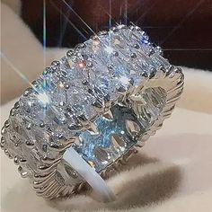 a large diamond ring sitting on top of a table