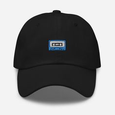 "Dad hats aren't just for dads. This one's got a low profile with an adjustable strap and curved visor. This retro cassette tape embroidered unisex cap comes in one size for adults. * 100% chino cotton twill * Unstructured, 6-panel, low-profile * 6 embroidered eyelets * 3 ⅛\" (7.6 cm) crown * Adjustable strap with antique buckle This product is made especially for you as soon as you place an order, which is why it takes us a bit longer to deliver it to you. Making products on demand instead of in bulk helps reduce overproduction, so thank you for making thoughtful purchasing decisions!" Retro Cassette, Cassette Tape, Cassette Tapes, Dad Hat, Trucker Cap, Dad Hats, Low Profile, Cotton Twill, Baseball Cap