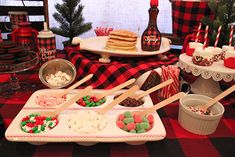 a table topped with lots of desserts and cookies on top of it's trays