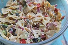 a bowl filled with pasta salad on top of a blue table