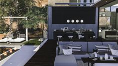 an outdoor living area with couches and tables