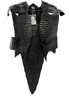 This black croc-skin vest with spikes is all about rock vibes and boldness. Throw it on with leather pants and high boots for a gothic edge.The spikes bring that extra fierceness, making this vest a perfect pick for those who want an expressive outfit with a rock 'n' roll touch.Size MMade in US Rock Vest, Black Fitted Punk Vest, Black Cotton Punk Vest, Gothic Sleeveless Vest Outerwear, Studded Leather Vest, High Boots, Alligator, Rock N Roll, Leather Pants