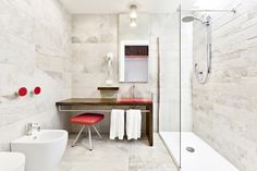 a bathroom with a sink, mirror and bathtub next to a stand up shower