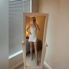 a woman taking a selfie in front of a mirror with her reflection wearing sandals