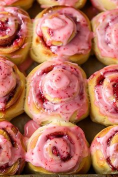 there are many pastries with pink icing on them