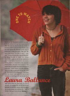 a woman is holding an umbrella and smiling