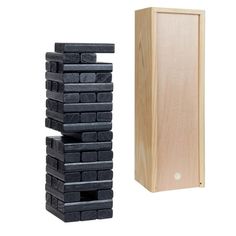 a stack of black bricks next to a wooden box