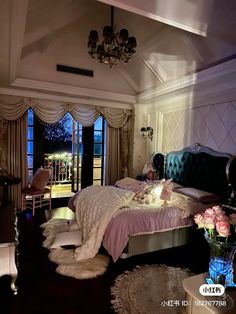 a bed room with a neatly made bed and a chandelier