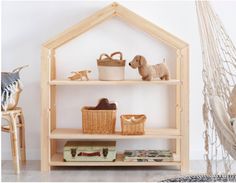 a wooden shelf with baskets and shoes on it in front of a hammock