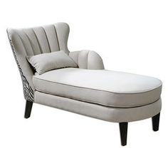 an upholstered chaise lounge chair with pillows