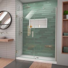 a bathroom with a glass shower door next to a sink and wooden shelves on the wall