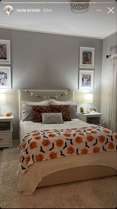 a bedroom decorated in gray and orange with pictures on the wall above the headboard