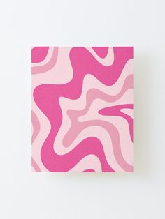 a pink and white abstract painting on a wall