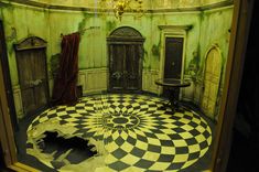 a room with a checkered floor and chandelier