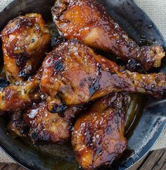 chicken wings in a skillet on a wooden table