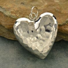 Sterling Silver Puffed Heart Charm - Hammered Heart, Valentines, Puffy Pendants, Big Heart, Heart Pendant, Silver Puffed Heart, Mother's Day Gifts Sterling Silver Hammer Finish Puffed Heart. An adorable charm! Whether swinging from a delicate chain necklace or dangling on a beaded bracelet, this little charm is sure to please. THIS LISTING IS FOR ONE (1) CHARM. PHOTO FOR DISPLAY ONLY. Large Heart - H: 8.0 L: 25.0 W: 25.0mm Includes a 7 mm soldered jump ring not included in measurements. Small He Jewelry Wallpaper, Hammered Silver Jewelry, Silver Jewelry Diy, German Silver Jewelry, Jewelry Bracelets Silver, Large Heart, Puffed Heart, Puffy Heart, Silver Jewelry Rings