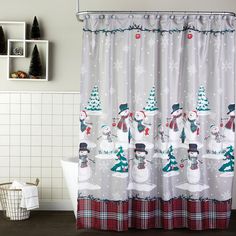 the shower curtain is decorated with snowmen and trees