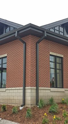 a red brick building with black metal roofing