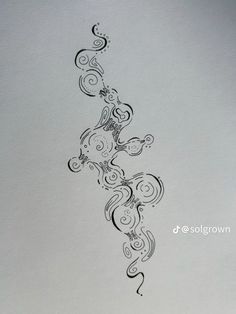 an artistic tattoo design on the back of a sheet of paper with swirls and dots