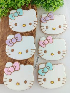 hello kitty cookies are sitting on a cutting board