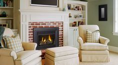 a living room filled with furniture and a fire place in front of a flat screen tv