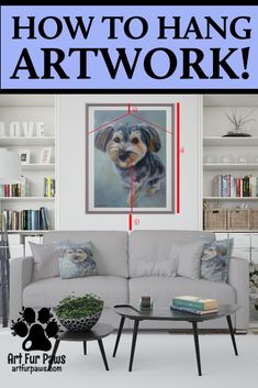 how to hang art work on the wall above a couch and coffee table in a living room