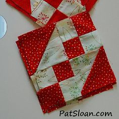 two pieces of red and white quilted fabric