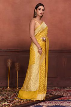 Radiate elegance on festive occasions in this stunning mango yellow Katan silk Banarasi saree with over all zari work. It comes with a matching blouse piece. Disclaimer: The shown stitched blouse on the model is for display purpose only. The saree comes with a matching blouse piece and finished with fall and piko. Elegant Yellow Blouse Piece With Self Design, Yellow Chikankari Traditional Wear In Georgette, Traditional Yellow Pre-draped Saree With Self Design, Festive Semi-stitched Yellow Traditional Wear, Festive Yellow Semi-stitched Traditional Wear, Traditional Yellow Banarasi Silk Blouse Piece, Yellow Anarkali Blouse With Chikankari Embroidery, Designer Yellow Lehenga With Self Design, Yellow Cutdana Traditional Wear In Georgette