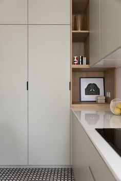 an image of a kitchen with white cabinets