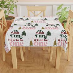 a christmas table cloth with the words fun it's to be one on it