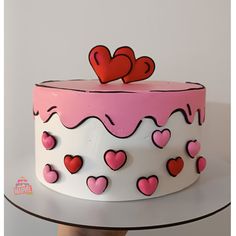 a pink and white cake with hearts on top