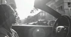 a man sitting in the driver's seat of a car