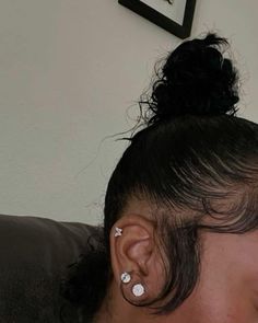 a woman with ear piercings sitting on a couch