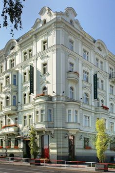 a large white building sitting on the side of a road