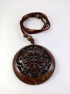 a brown necklace with an intricate design on it