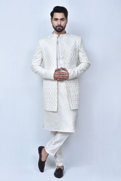 Cream sherwani with thread, sequin embroidery in mughal pattern. Paired with kurta and straight pant.
Components: 3
Pattern: Embroidery
Type Of Work: Thread, sequin, mughal
Neckline: Mandarin collar
Sleeve Type: Full sleeves
Fabric: Art Silk
Color: Cream
Other Details: 
Front concealed button placket
Side pockets
Elasticated waistband
Occasion: Destination Wedding - Aza Fashions Designer Sherwani With Intricate Embroidery And Straight Kurta, Eid Raw Silk Sherwani With Intricate Embroidery, Eid Sherwani With Intricate Embroidery In Raw Silk, Festive Naqshi Raw Silk Sets, Diwali Sherwani With Intricate Embroidery, Designer Raw Silk Sherwani Straight Kurta, Designer Raw Silk Sherwani In Straight Kurta Style, Traditional Festive Sherwani With Naqshi Detailing, Raw Silk Sherwani With Dabka Work