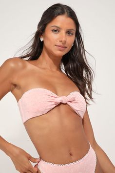 The Dippin' Daisy's Bunny Light Pink Eyelet Tie-Front Strapless Bandeau Bikini Top is the sweetest summer look you'll ever see! Sleek and stretchy tricot knit, with lace-lace eyelet embroidery, shapes a tie-front silhouette that forms a strapless bandeau-style bikini top. White looped trim, supportive side boning, and removable padding. Fit: This garment fits true to size. Length: Size medium measures 5.5" from top to bottom. Bust: Works best for A to C cup sizes. Fabric: Fabric is very stretchy Strapless Tube Top For Beach Season, Strapless Tube Top For Beachwear, Chic Summer Swimming Tube Top, Chic Strapless Tube Top For Poolside, Flirty Halter Neck Tube Top For Summer, Flirty Tube Top For Summer Vacation, Flirty Bandeau Tube Top For Summer, Chic Strapless Swimwear For Beach Season, Fitted Strapless Tube Top For Beach