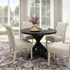 a dining room table with four chairs around it