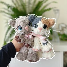 a person holding two stuffed animals in their hands