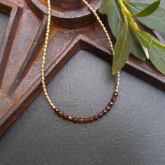 A dainty beaded necklace featuring faceted and polished hessonite garnet stones. I've paired them with tiny gold Czech glass seed beads in two sizes. The necklace is finished with a gold filled spring ring clasp, gold plated extender chain, and one final wire wrapped garnet stone. Coordinating earrings are available in the link below. Necklace length: 15 3/4" plus 2" extender chain Coordinating Earrings https://www.etsy.com/listing/1757148401/dainty-hessonite-garnet-gold-earrings?click_key=15f401c6f0333850de10aeaa6dbec6253ba4a2aa%3A1757148401&click_sum=7db057ea&ref=shop_home_active_11&sts=1 Beaded Necklace Collection: https://www.etsy.com/shop/BonArtsStudio?ref=seller-platform-mcnav&section_id=17053954 See What's New: https://www.etsy.com/shop/BonArtsStudio?ref=seller-platform-mcnav&sectio Red Stone Necklace, Layering Jewelry, Garnet And Gold, Necklace Collection, Hessonite Garnet, Garnet Stone, Bead Chain, Layered Jewelry, Necklace Dainty