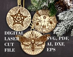 three gold medallions with different symbols on them next to pine cones and evergreen branches