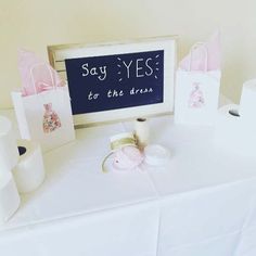 a sign that says say yes to the dress and some rolls of toilet paper next to it