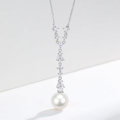 Freshwater Akoya Pearl & Cubic Zirconia Y-Shape Necklace Step into a world of refined elegance with our 10-11mm Freshwater Akoya Pearl Cubic Zirconia Pendant Necklace. This sophisticated Y-shaped chain is intricately adorned with precisely set cubic zirconia, leading to a stunning large freshwater Akoya pearl pendant. With a length of 40cm and an additional 5cm extension, this necklace provides a graceful drape that complements any neckline. Perfectly suited for evening gowns, bridal wear, or a Elegant Crystal Necklace With Pearl Pendant, Elegant Cubic Zirconia Teardrop Pendant Necklace, Elegant Crystal Drop Bridal Necklace, Elegant Bridal Necklace With Pearl Drop And Cubic Zirconia, Elegant Crystal Pearl Necklace With Pendant, Formal Pearl Necklaces With Sparkling Stones, Elegant Pearl Drop Necklace With Cubic Zirconia, Elegant Diamond White Drop Necklaces, Elegant Cubic Zirconia Necklace With Pearl Drop