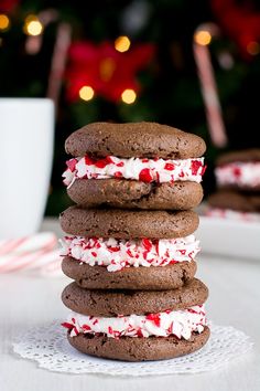 three cookies stacked on top of each other with white and red sprinkles