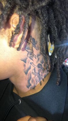 a man with dreadlocks and tattoos on his face