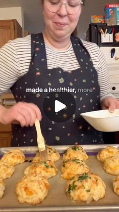 a woman in an apron is making mini muffins