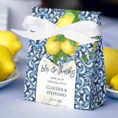 a blue and white box with lemons on it sitting in front of some plates