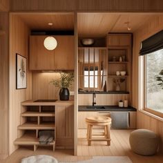 a kitchen with wooden walls and flooring next to a window in a room filled with furniture