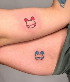 two people with tattoos on their legs, one has a bunny and the other has a pig